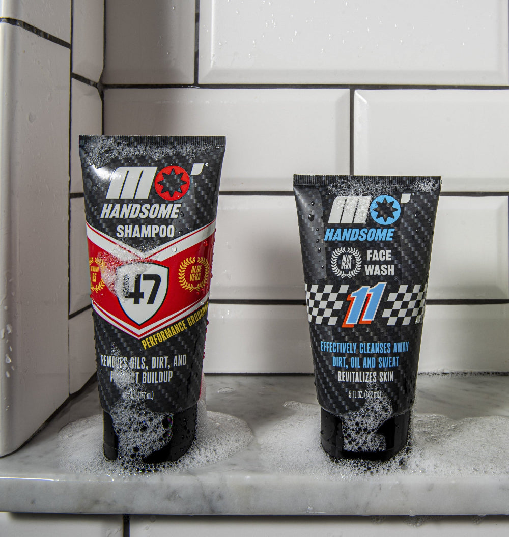Mo’Handsome shampoo and face wash in shower scene with soapy bubbles—high-performance grooming for men in action.