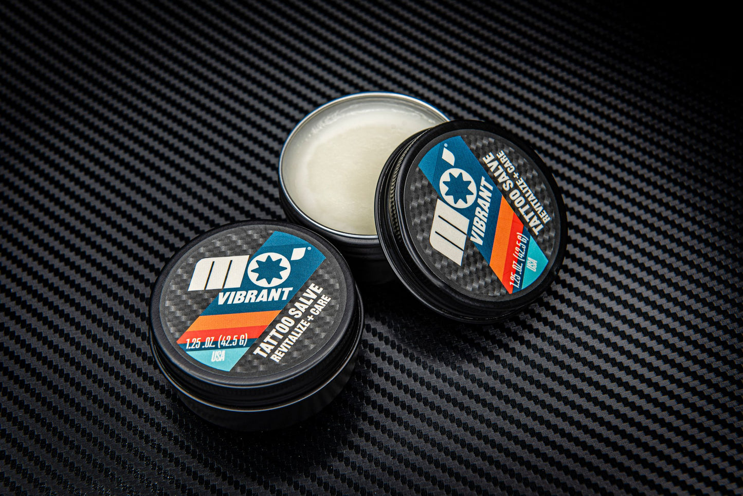 Tattoo salve in sleek black tins—Mo’Handsome skincare for active men with bold, lasting tattoos.