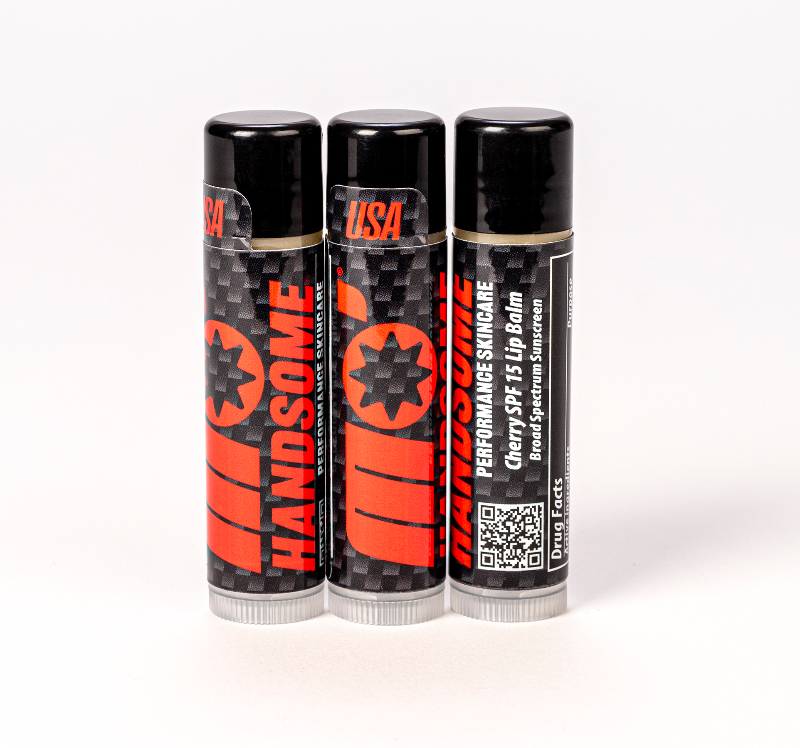 Mo’Handsome SPF 15 cherry lip balm triple pack with carbon fiber design—luxurious lip care for bold, active men.