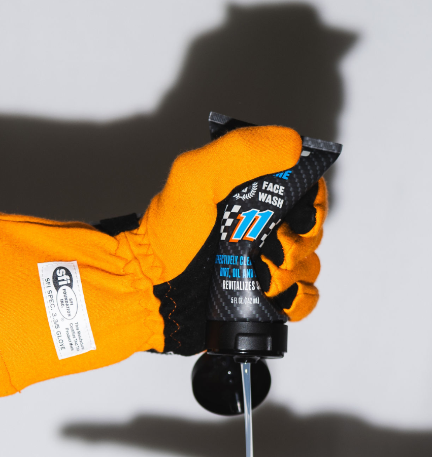 Mo’Handsome face wash tube squeezed by race glove—engineered for men who live life in the fast lane.