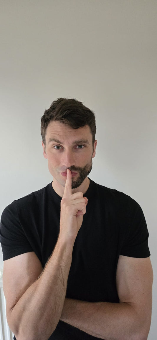 Handsome man with a well-groomed, clean half-shave demonstrating the results of a quality shave.