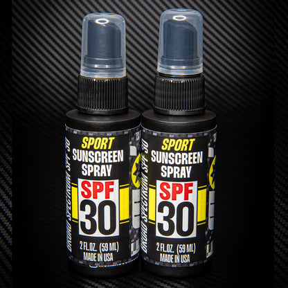 2 pack spf 30 sport sunscreen spray TSA approved standing on black carbon fiber background